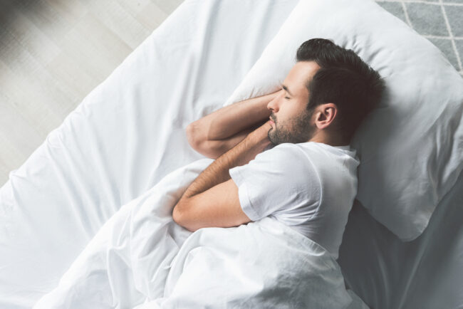 Cute,Young,Man,Sleeping,On,Bed