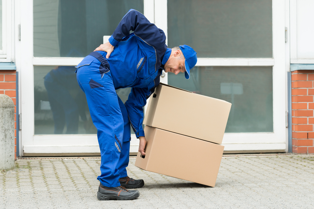 Delivery,Man,Suffering,From,Backpain,While,Lifting,Boxes Back Pain Risk Factors You Can Change