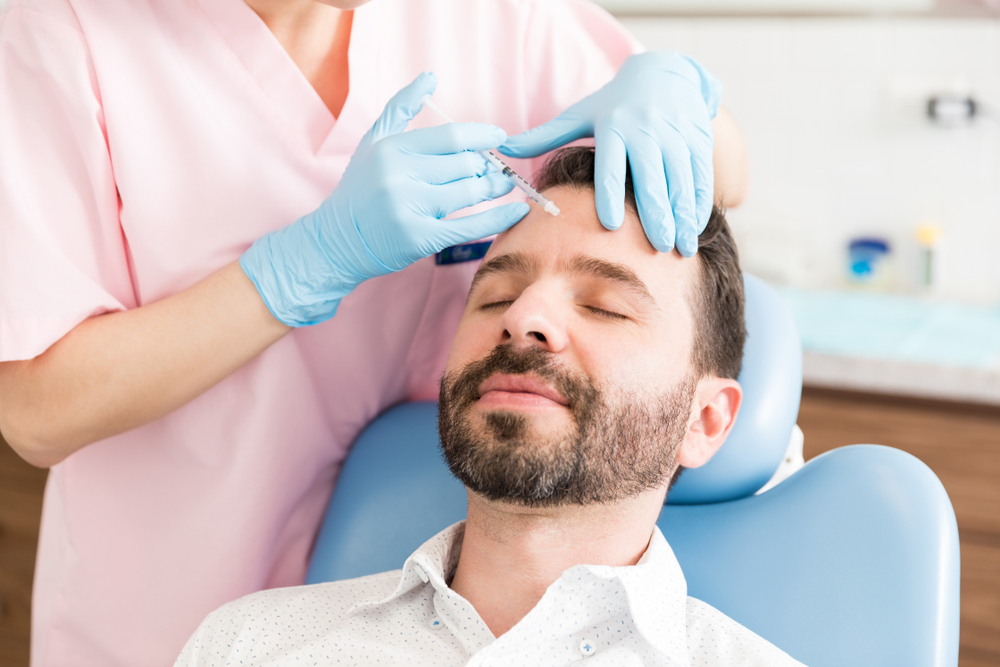Calm,Male,Patient,Receiving,Wrinkle,Smoothing,Injection,By,Surgeon,In Botulinum Toxin Injectables for Migraines