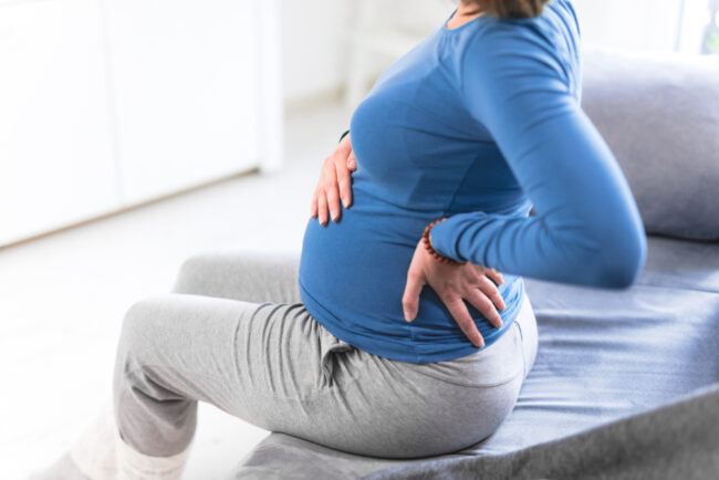 Pregnant,Tired,Exhausted,Woman,With,Stomach,Issues,And,Back,Pain